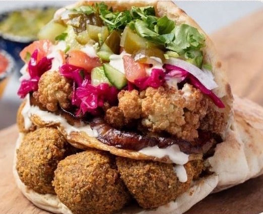 A loaded falafel pita with fresh toppings